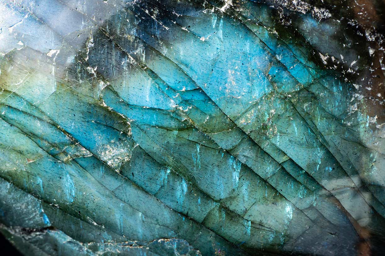 Macro photo of a colorful and illuminated labradorite stone with iridescent textures and luminous colors